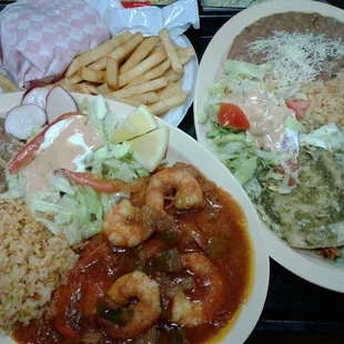 About to enjoy  this delicious food.camarones rancheros. Enchiladas  verdes .hamburger  special.