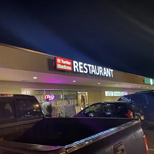 the back of a truck parked in front of a restaurant