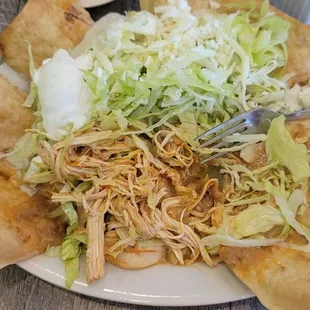 Taco salad with chicken. Menu does not list onions, tomatoes and peppers but it came all cooked together. They said ita precooked this way.