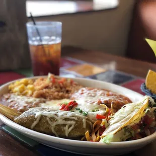 macho combo. (chile relleno, a chicken &amp; sour cream enchilada, beef barbacoa crispy taco &amp; chicken tamale with refried beans &amp; rice)