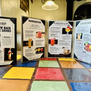 a table with a menu and drinks