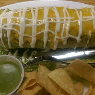 Burrito Mojado w/ Salsa Verde filled with Al Pastor, beans, rice, cilantro... Really good