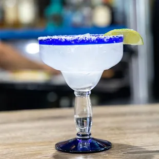 a margarita with a lime wedge