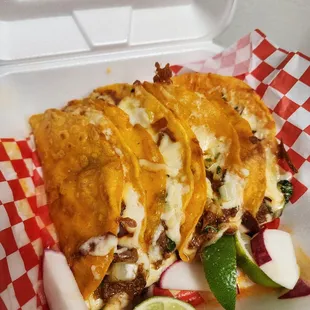 Quesa tacos. It's a cheesy Birria taco that's juicy and delicious. Can't go wrong with them.