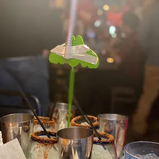  tray of cocktails and a flower