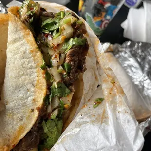 a burrito wrapped in aluminum foil