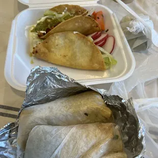 Papas (potato) tacos on the top and carnitas and carne asada on the bottom. These were ordered to go