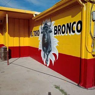 a bull painted on the side of a building