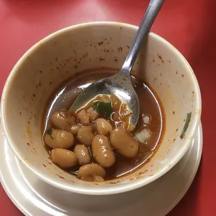 Pure magic!  Free charro beans swim in spicy soup, onion, &amp; meat bits.  Soooo good, ate wife&apos;s &amp; ordered more. Drank broth after. Mmmmm.