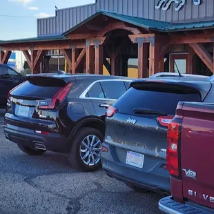 several cars parked in front of a building