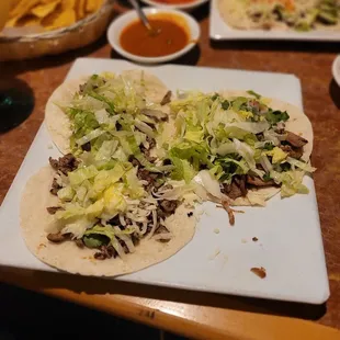 1 carnita and 2 carne asada flour taco