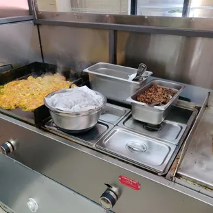 Grilling chicken and already grilled asada for tacos and burritos