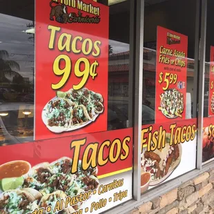 a taco's 99 cents sign in the window