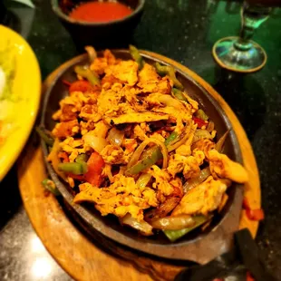 a plate of mexican food and a glass of wine