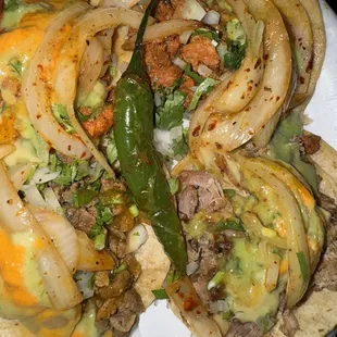 Two in the back are Al pastor, 1 asada left front and 1 carnitas right front