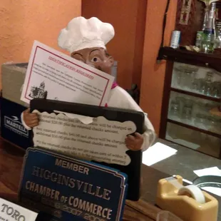 a chef holding a menu