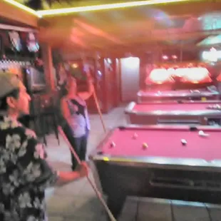 a man and woman playing pool