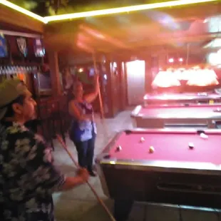 a man and a woman playing pool
