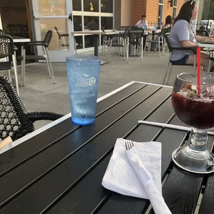a table with a drink and a napkin on it