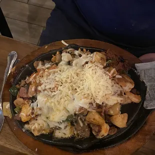 Molcalambres: fajitas with sausage, bacon, steak, chicken, shrimp, pineapple, onions, peppers, and cheese