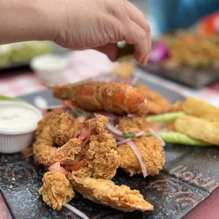 a plate of fried chicken with dipping sauce