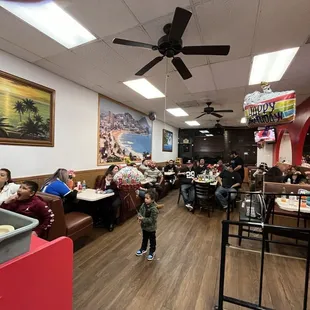 a child standing in the middle of the restaurant
