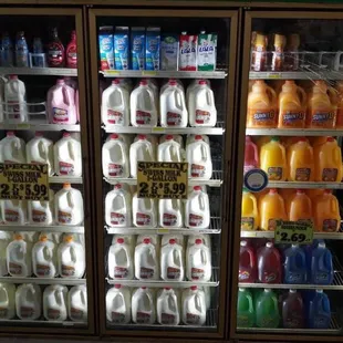 a refrigerated display of milk and juices