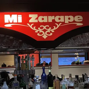 a bar counter with bottles of alcohol