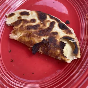 a slice of quesadilla on a red plate