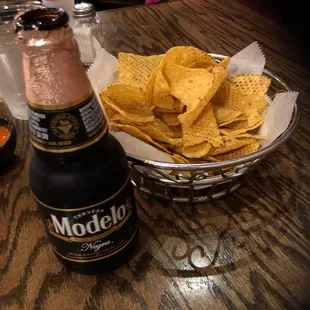 a plate of chips and a bottle of beer