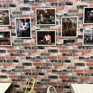 a brick wall with pictures on it