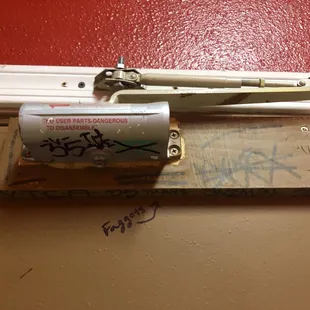 a door handle with graffiti on it