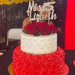 a wedding cake with red roses