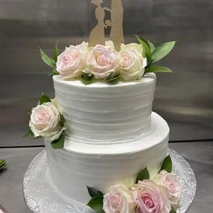 a wedding cake decorated with roses