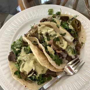 two tacos on a white plate