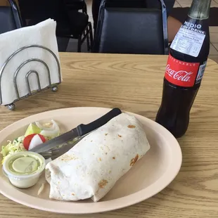 a plate of food and a bottle of coke