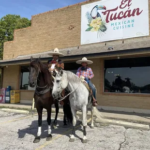 two people riding horses