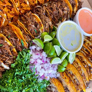 a platter of tacos and salsa