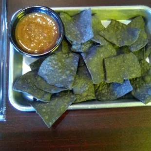 At El Vagon Tacos. Strange dark chips. Not good. The salsa was mostly tasteless and kind of weird. Not good.