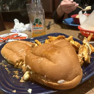 a sandwich and fries on a blue plate