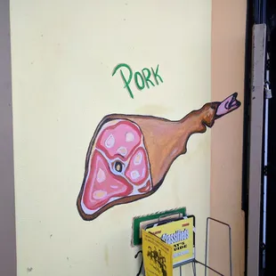 a piece of meat painted on a wall