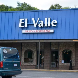 a van parked in front of the restaurant