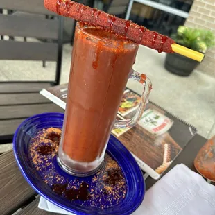 a bloody drink on a blue plate