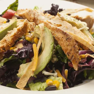 a salad with chicken and avocado