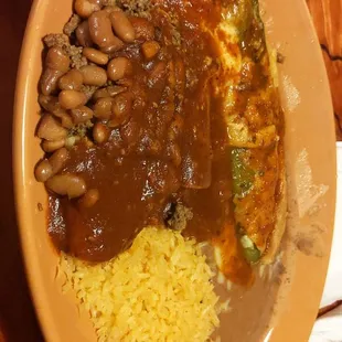 Plate one of the fiesta dinner, rice, beans, Chile relleno, tamale, enchilada