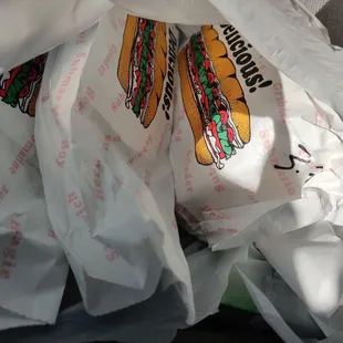 a sandwich wrapped in plastic