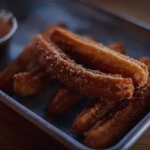 Churros with chocolate sauce.