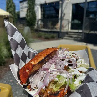 a hand holding a sandwich