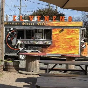El Veneno truck with a great seating area with tables and umbrellas