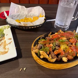 a plate of nachos and a glass of water